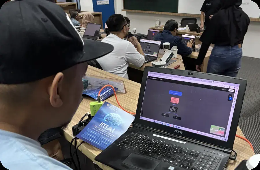 Participant building an AI workflow on a laptop